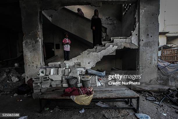 Palestinian woman stands in his home destroyed during the 50-day conflict between Hamas militants and Israel, in Shejaiya neighbourhood in the east...