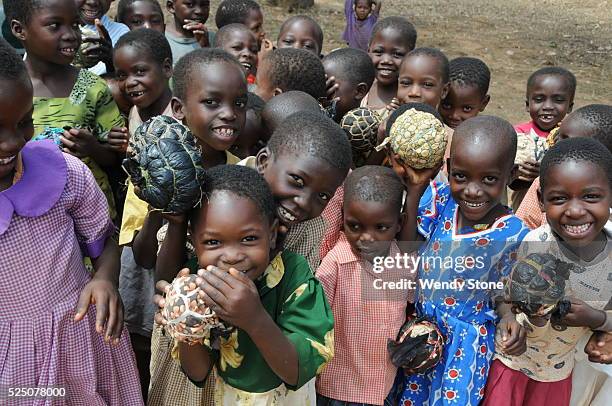 Early Childhood Development Center. Children play outside with the plastic bag balls. Balls are made from rolled up plastic bags tied together with...