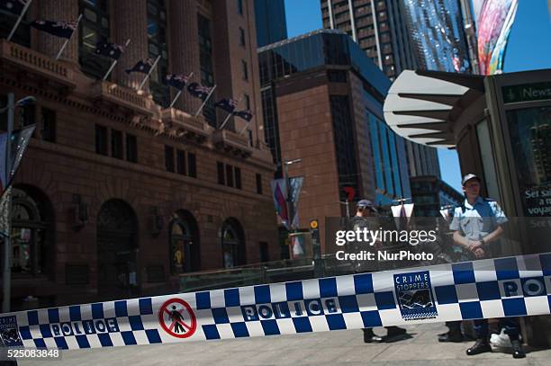 Office workers are evacuated from a building as parts of Sydney's central business district remain closed following a hostage incident on December...
