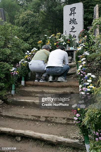 Relatives of the victims of the 1985 Japan Airlines jumbo jet crash pray in front of the victims' monument at Osutaka Ridge north of Tokyo, Japan,...