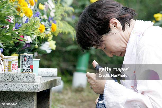 Relatives of the victims of the 1985 Japan Airlines jumbo jet crash pray in front of the victims' monument at Osutaka Ridge north of Tokyo, Japan,...