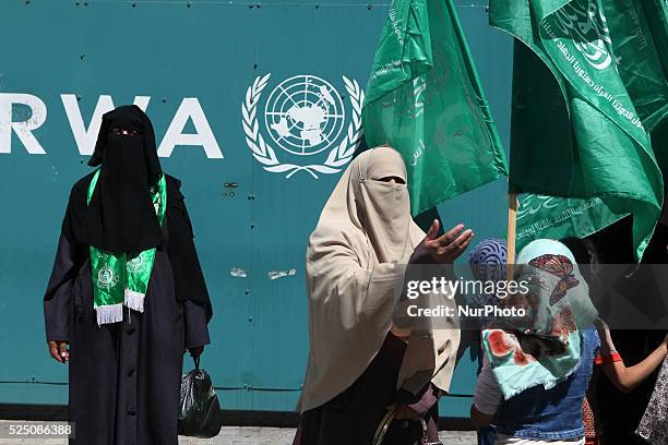 Palestinian women supporting the Hamas take part in a protest against the reduction of educational programs given by the United Nations Relief and...