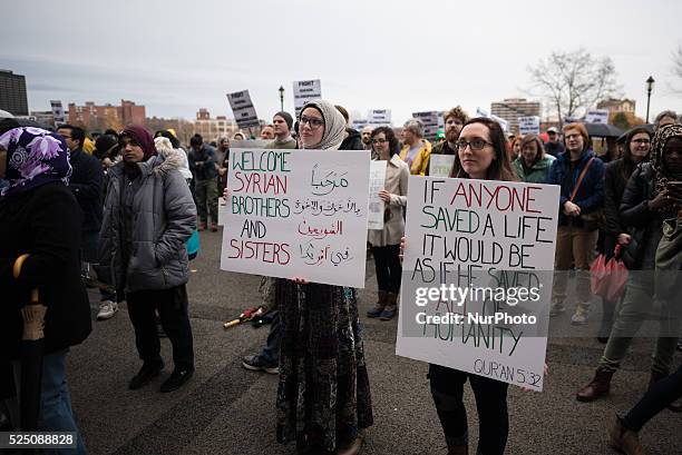 Rally goers display creative signs with various languages and messages to show thier solidarity and support with refugees on a rainy November day in...