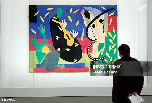 Visitor looks at a painting The sorrows of the king of Henri Matisse as part of the opening of the exhibition "Keys to a Passion" at the Louis...