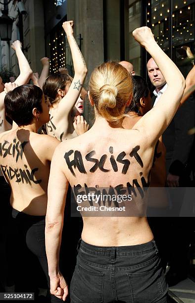 Topless activists of the Ukrainian women movement Femen demonstrate during a "Fascist's epidemic" protest to disturb a press conference of French...