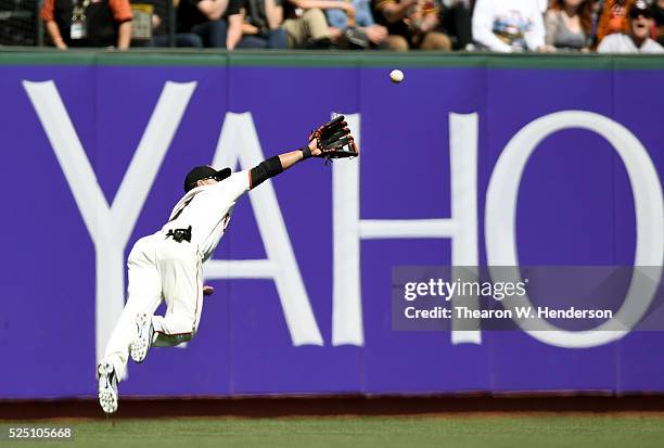 Gregor Blanco of the San Francisco Giants dives to rob Derek Norris of the San Diego Padres of a hit in the top of the eighth inning at AT&T Park on...