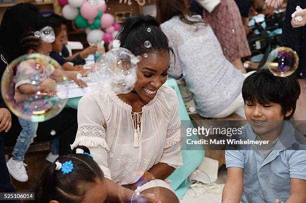 Singer Kelly Rowland interacts with guests during the Baby2Baby Mother's Day Party presented by Tiny Prints at AU FUDGE on April 27, 2016 in West...