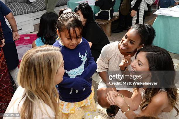 Model/co-president of Baby2Baby Kelly Sawyer Patricof, singer Kelly Rowland, and co-president of Baby2Baby Norah Weinstein interact with during the...