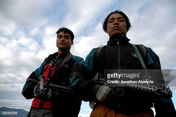 Two People's Liberation Army fighters rest before returning to their battalion February 15, 2005 in the western Terai district near Dahaban, Nepal....
