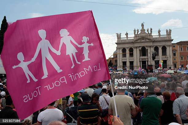 People hold placards against gender ideology during a mass demonstration in St.John Square in Rome on June 20, 2015. Hundreds of thousands of people...