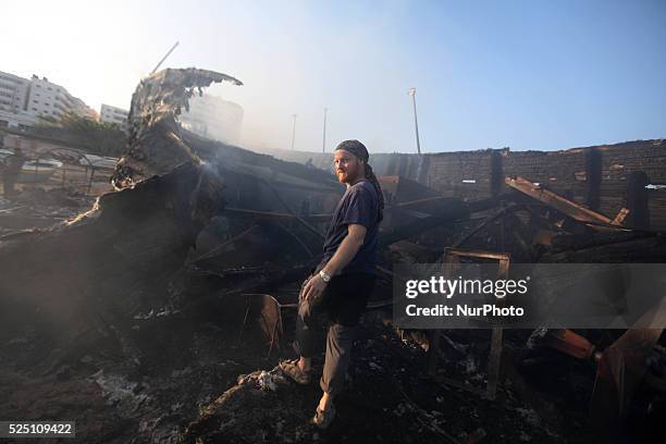 Canadian chief project of peace activist boat &quot;Gaza's Ark&quot; checks damages to his burnt boat following an Israeli air strike during the...