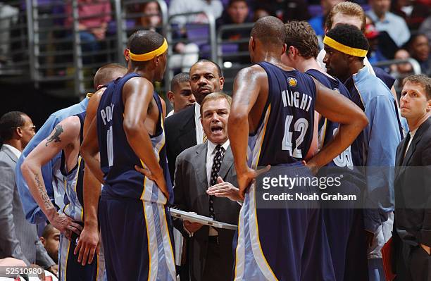 Head coach Mike Fratello of the Memphis Grizzlies huddles his players on the sideline during a timeout in the game against the Los Angeles Clippers...