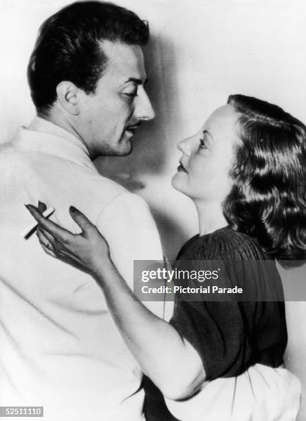 American actress Tallulah Bankhead and her husband actor John Emery dance and smoke, 1937.