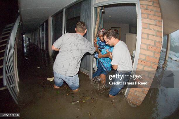 Michael Latka and John Gulizia with the United States Navy rescue Lillie Williams from Hurricane Katrina's rapidly rising storm surge in Gulfport,...