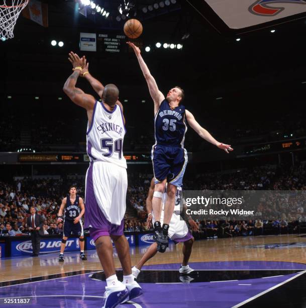 Brian Cardinal of the Memphis Grizzlies shoots a layup over Brian Skinner of the Sacramento Kings during a game at Arco Arena on March 8, 2005 in...