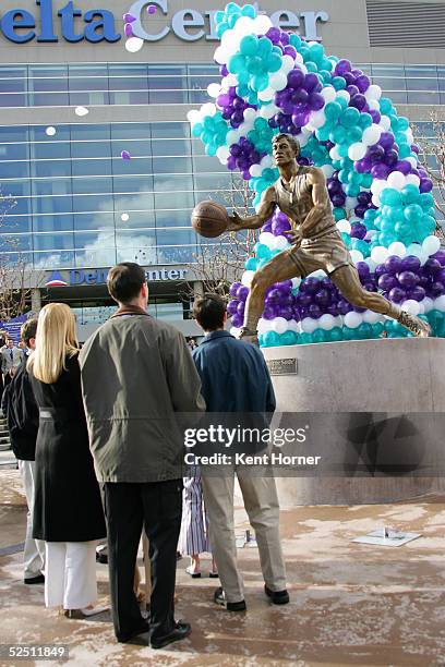 John Stockton, his wife Nada and son watch as balloons reveal his 9-foot bronze statue during the unveiling March 30, 2005 in front of the Delta...