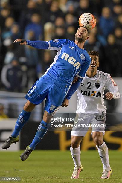 Argentina's Racing Club midfielder Washington Camacho vies for the ball with Brazil's Atletico Mineiro defender Marcos Rocha during their Copa...