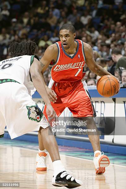 Jason Hart of the Charlotte Bobcats is defended by Troy Hudson of the Minnesota Timberwolves during the game at Target Center on March 8, 2005 in...