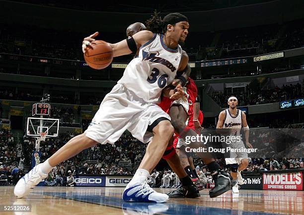 Etan Thomas of the Washington Wizards drives past Obinna Ekezie of the Atlanta Hawks on March 30, 2005 at the MCI Center in Washington, DC. The...