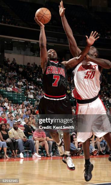 Ben Gordon of the Chicago Bulls shoots against Emeka Okafor of the Charlotte Bobcats on March 30, 2005 at the Charlotte Coliseum in Charlotte, North...