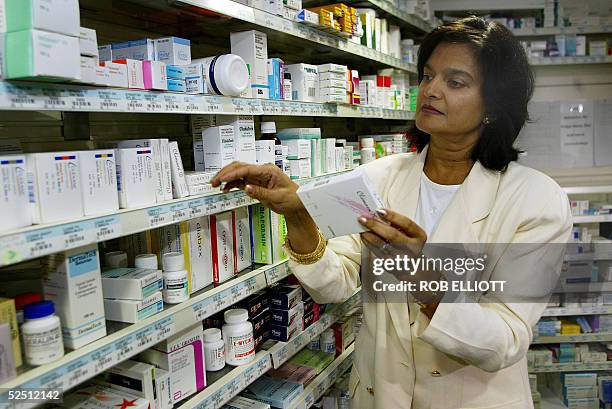 Consultant pharmacist Pratibha Patel checks shelf drugs at the Soul Pattinson Chemist in the Metcentre in Sydney, 31 March 2005, as the...