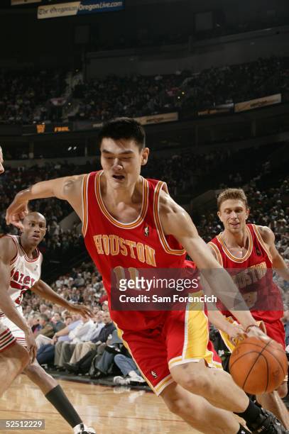 Yao Ming of the Houston Rockets drives the ball to the hoop against the Portland Trail Blazers on March 30, 2005 at the Rose Garden Arena in...