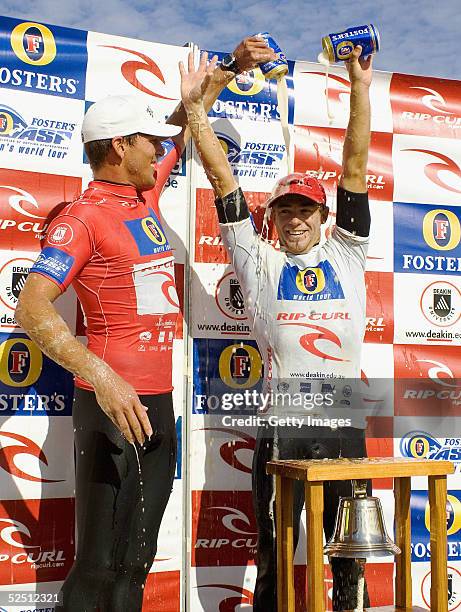 Trent Munro of Australia has a can of lager poured over his head by Andy Irons of USA after winning the Rip Curl Pro, part of the World Championship...