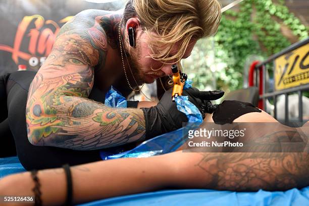 June 06, 2015: An Israeli woman gets her body tattooed during the 3rd annual tattoo convention in Tel-Aviv on June 6, 2015.The Convention hosted...