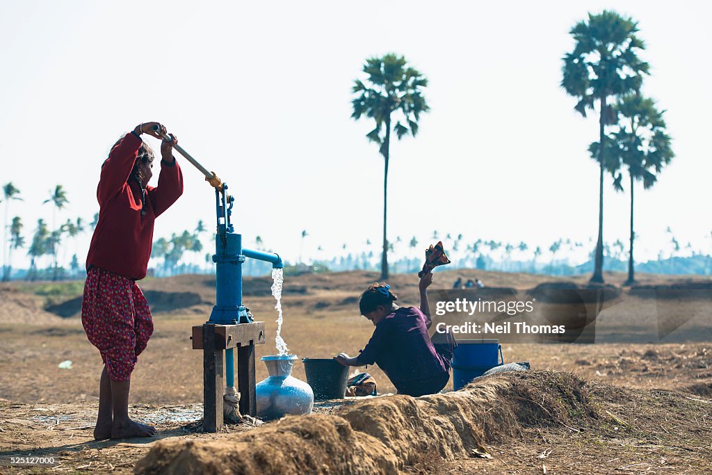 Rohingya girl pumps water at an IDP Camp in Rakhine State, Burma.