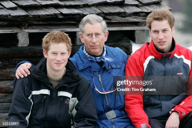 Prince Charles with his arms around Prince William and Prince Harry during the Royal Family's ski break in the region at Klosters on March 31, 2005...