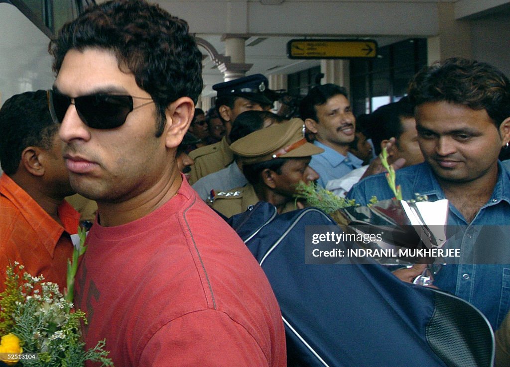 Indian cricketers Yuvraj Singh (2L) and