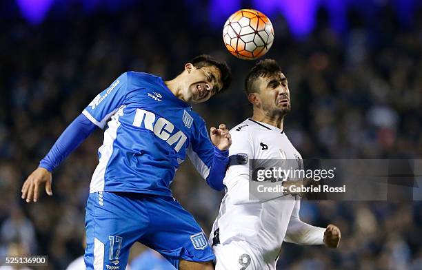 Marcos Acu��a of Racing Club and Lucas Pratto of Atletico Mineiro jump for a header during a first leg match between Racing Club and Atletico Mineiro...