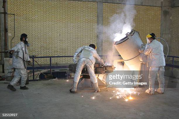 Technicians work inside of a uranium conversion facility producing unit March 30, 2005 just outside the city of Isfahan, about 254 miles , south of...
