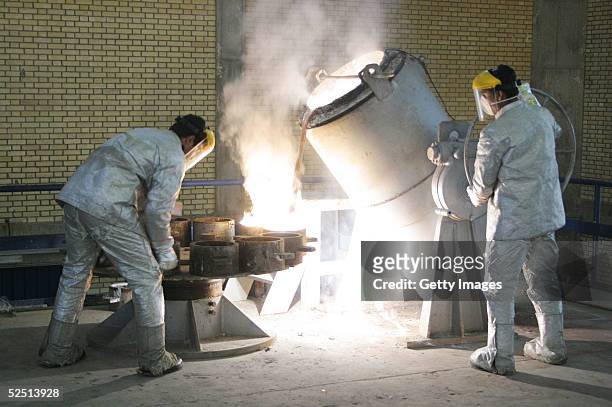 Technicians work inside of a uranium conversion facility producing unit March 30, 2005 just outside the city of Isfahan, about 254 miles , south of...