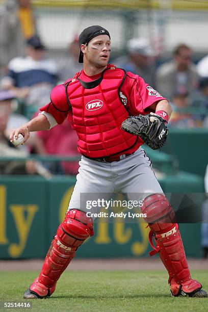 Catcher Jason LaRue of the Cincinnati Reds looks to throw the ball during a Spring Training game against the Pittsburgh Pirates on March 8, 2005 at...