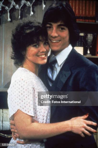 American actors Erin Moran and Scott Baio hold each other in a publicity still for the television show 'Joanie Loves Chachi,' in which they play the...