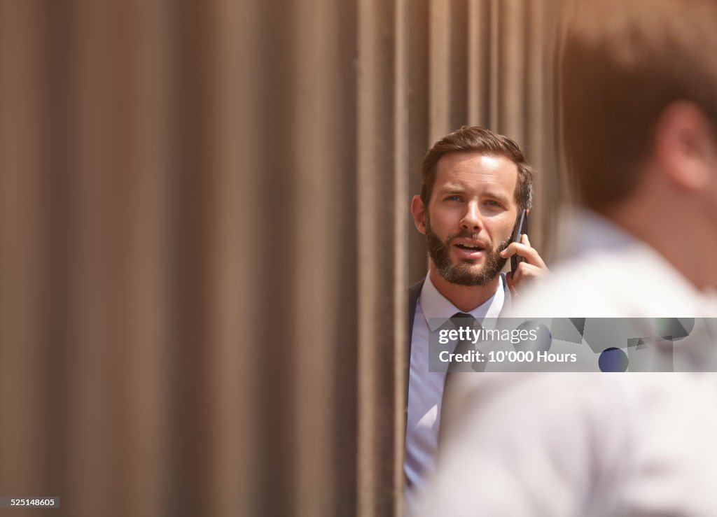 Businessman using a mobile phone outside