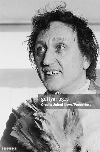 English comedian and singer, Ken Dodd pictured holding a feather duster or tickle stick in London on 16th November 1978.