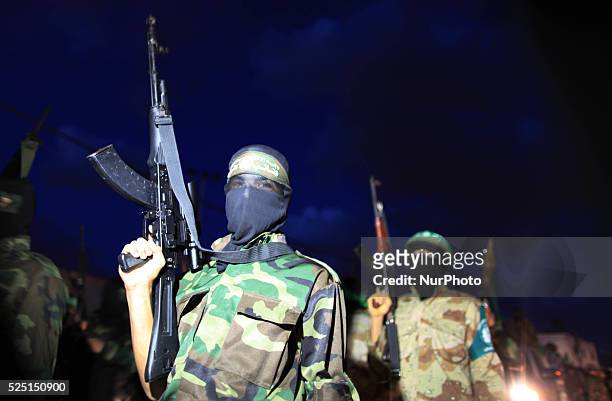 Members of Ezzedeen al-Qassam brigades, the armed wing of Hamas movement, march during a rally in solidarity with Palestinian prisoners in Israeli...