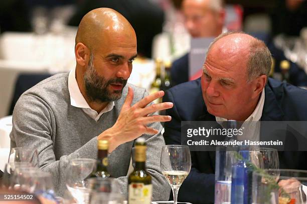 Josep Guardiola , head coach of Muenchen talks to Uli Hoeness during the Champions Banquette after the UEFA Champions League semi final first leg...