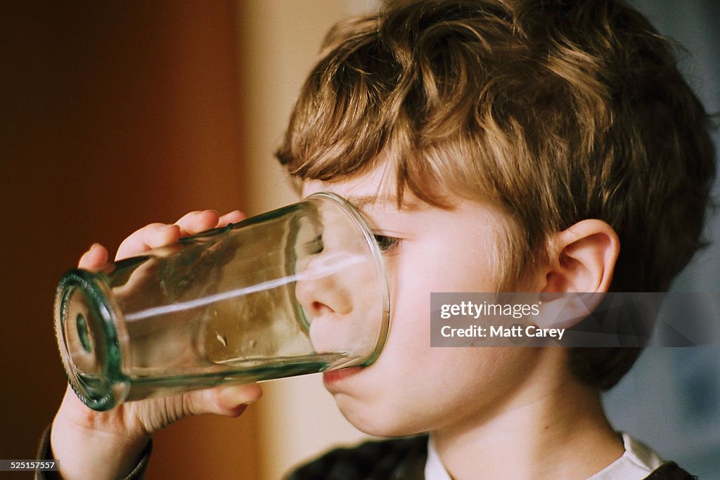 Young boy drinking water