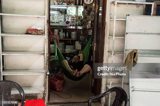 Woman is taking a nap, in Hanoi, July the 8th, 2015. After more than a week of high temperatures , people enjoy the rain and sudden fall of...