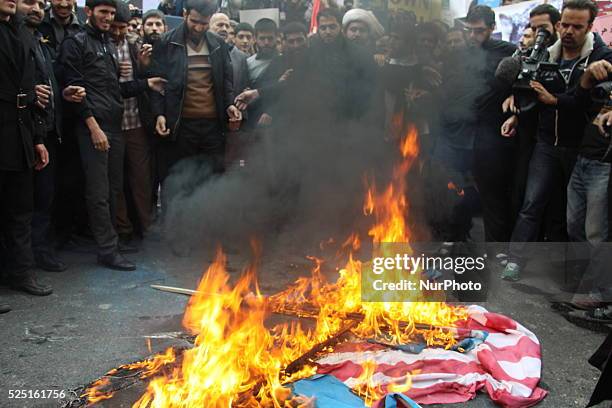 Iranians burn a US flag outside the former US embassy in the Iranian capital Tehran on November 4 during a demonstration marking the anniversary of...