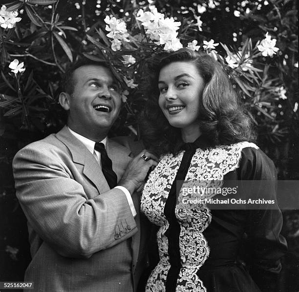 Actress Elaine Stewart with radio personality Johnny Grant attend the Garden party by Jimmy McHugh in Los Angeles,CA.