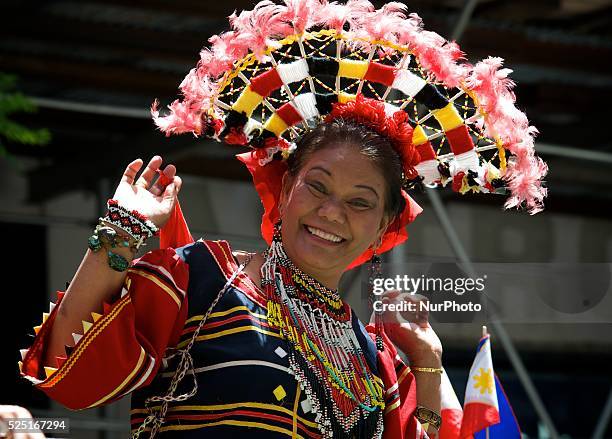 Folk dancer waves at the camera at the 116th anniversary celebration of the Philippine independence in New York City, June 1st 2014.