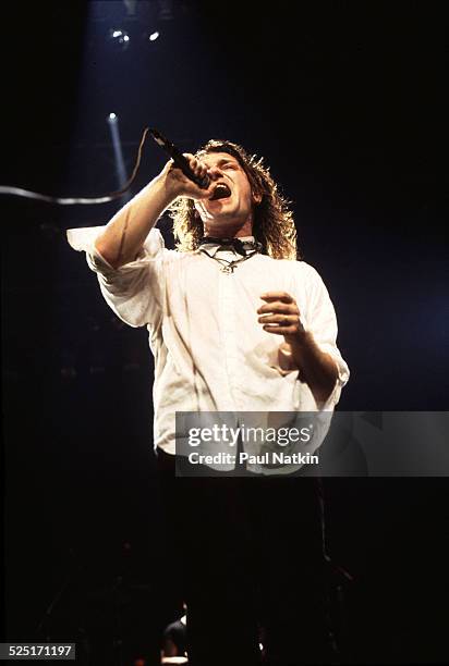 Musician Bono , of U2, performs during a concert on the Amnesty International Benefit Tour, Chicago, Illinois, June 12, 1986.