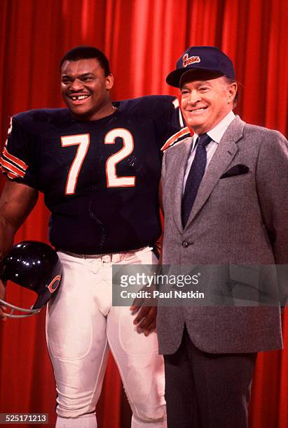 Football player William 'Refrigerator' Perry, defensive lineman for the Chicago Bears, poses with comedian Bob Hope on 'The Bob Hope Show', Chicago,...