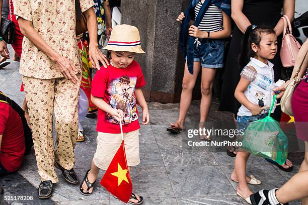 Little boy with a Vietnamese flag after the parade, in Hanoi, September 2nd 2015.