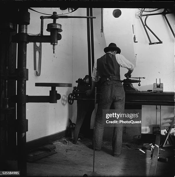 Wilbur Wright working in the Wright Brothers Ohio bicycle shop, circa 1900.