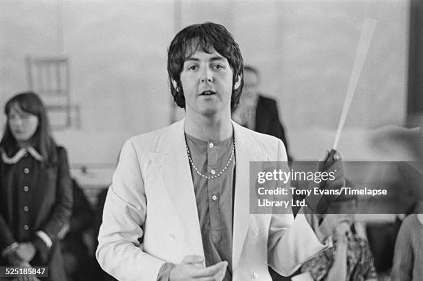 English musician, singer, songwriter, and composer Paul McCartney records the Lennon-McCartney composition 'Thingumybob' with the Black Dyke Mills...